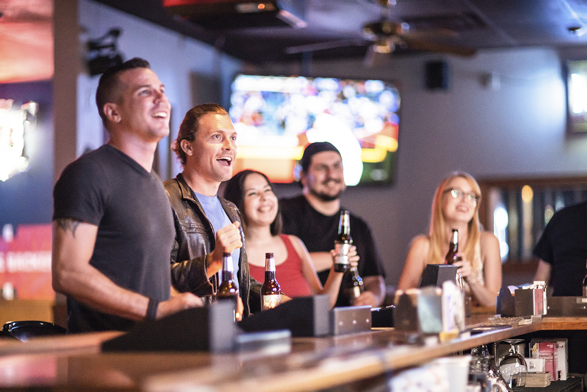 Friends at bar watching baseball